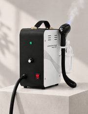 JBS Overheat Pro Steamer product image with visible white steam and subtle Nano Blue Light at the handpiece