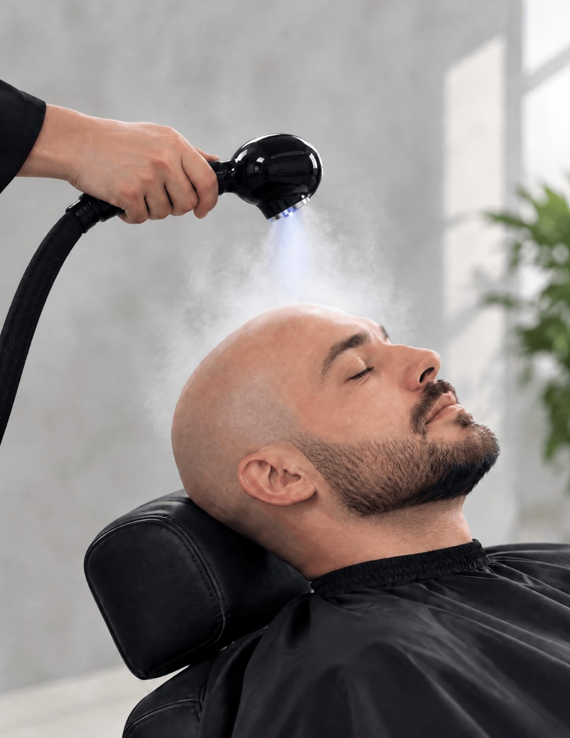 Professional bald-head steam treatment with subtle Nano Blue Light for barber scalp care