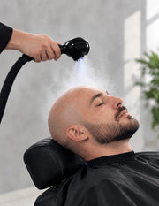 Professional bald-head steam treatment with subtle Nano Blue Light for barber scalp care