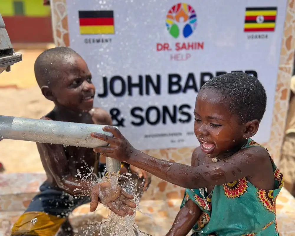 Kinder in Afrika an einem Trinkbrunnen